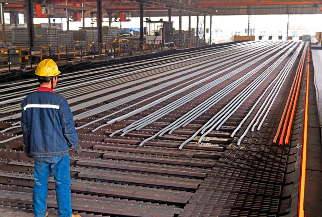 In this photo taken on March 10, a worker stands in a steel workshop in Zouping, in China’s eastern Shandong province (AFP file photo)