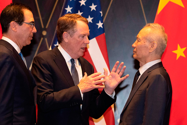 United States Trade Representative Robert Lighthizer (centre) gestures as he chats with Chinese Vice Premier Liu He (right) as US Treasury Secretary Steve Mnuchin (left) looks on after posing for a ‘family photo’ at the Xijiao Conference Centre in Shanghai on Wednesday  (AFP photo)