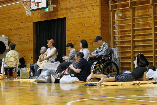 Evacuated residents sit inside a shelter to wait out the storm in Tokyo, on Saturday, ahead of Typhoon Hagibis (AFP photo)