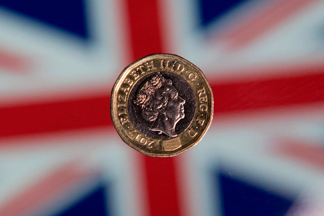 A British one pound sterling coin is arranged in front of a Union flag for a photograph in London on December 14, 2017  (AFP file photo)