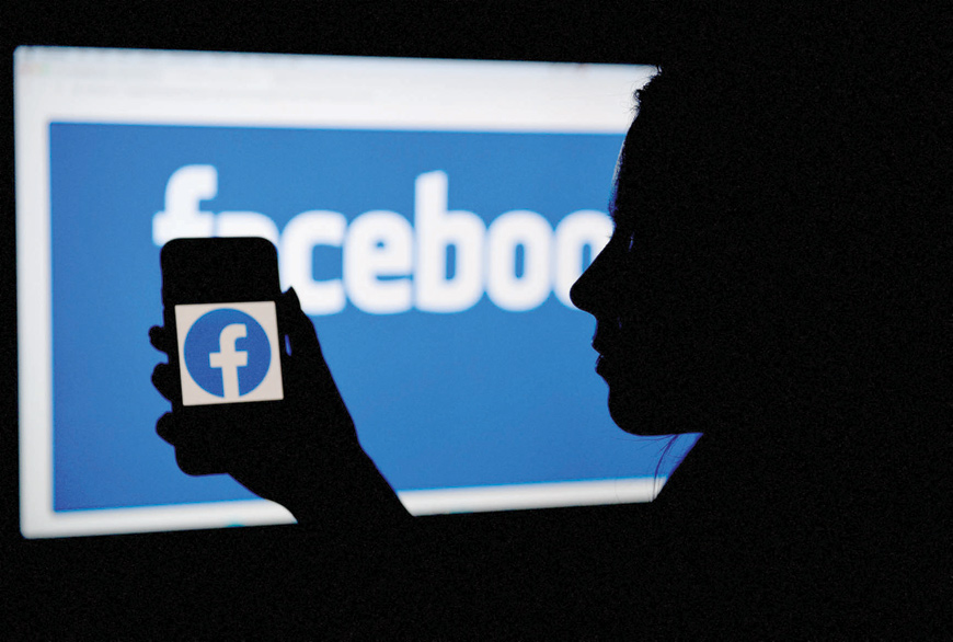 In this file photo illustration, a smart phone screen displays the logo of Facebook on a Facebook website background, on April 7, in Arlington, Virginia (AFP photo)