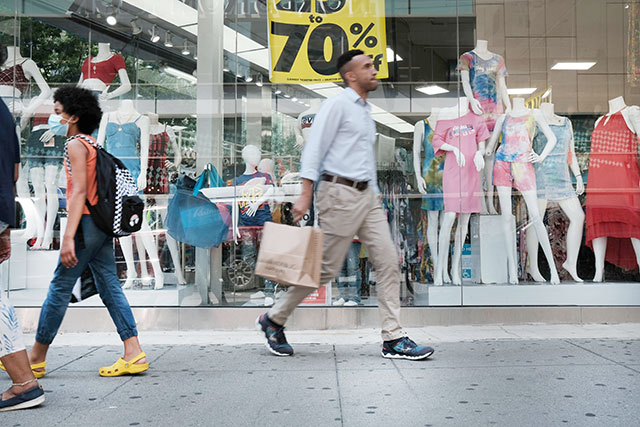 People walk through a shopping district in Brooklyn on July 16, 2021 in New York City.  (AFP photo)