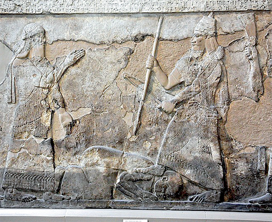In this alabaster bas-relief, the Assyrian King Tiglath-Pileser III( right) stands over an enemy’s right shoulder (Photo courtesy of the British Museum)