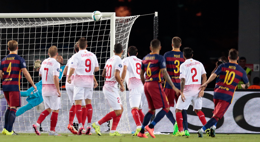 Barcelona’s Lionel Messi (right) shoots a free kick to score his side’s first goal during the UEFA Super Cup football match between FC Barcelona and Sevilla FC at the Boris Paichadze Dinamo Arena Stadium in Tbilisi, Georgia, on Tuesday (AP photo)