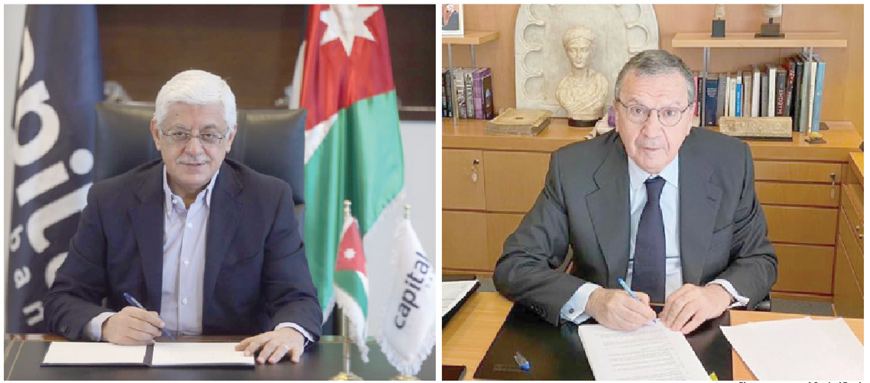 Chairman of Capital Bank Group Bassem Khalil Al Salem (left) and Chairman and Group CEO of Bank Audi Samir Hanna sign an acquisition agreement  (Photo courtesy of Capital Bank)