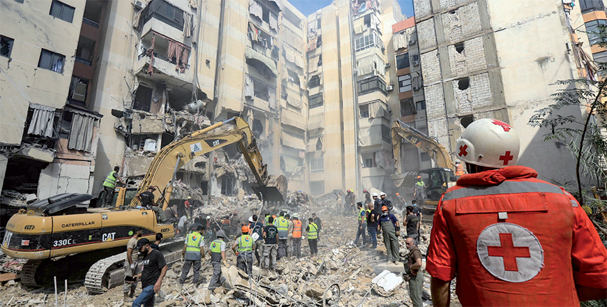Rescuers sift through the rubble at the scene of an Israeli strike that targeted Beirut's southern suburbs a day earlier, as search and rescue operations continue on Saturday (AFP photo)