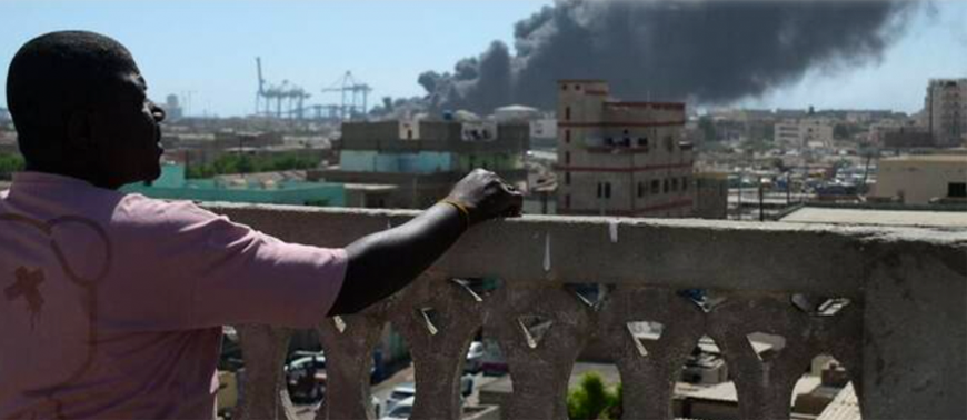A man watches as smoke billows after a drone strike on the port of Port Sudan on May 6, 2025 (AFP photo)