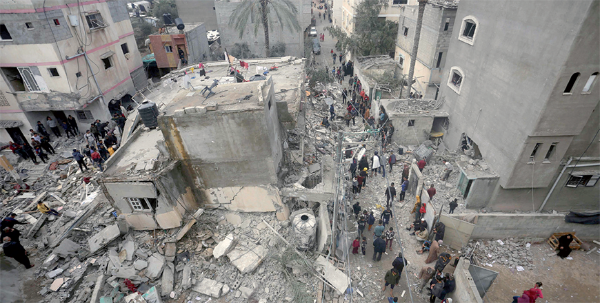 People search for victims in the rubble of the Baraka family home in Deir Al Balah in the central Gaza Strip after it was hit in an Israeli air strike on Sunday (AFP photo)