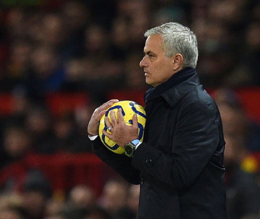 Tottenham Hotspur’s Portuguese head coach Jose Mourinho gathers the ball during their English Premier League football match against Manchester United in Manchester, England, on Wednesday (AFP photo by Oli Scarff)