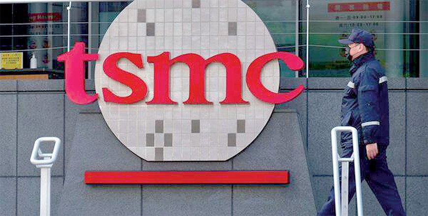 A security guard walks past a company logo at the headquarters of the world's largest semiconductor maker TSMC (AFP File photo)