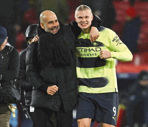 Manchester City’s Spanish manager Pep Guardiola (left) celebrates with Manchester City’s Norwegian striker Erling Haaland after their English Premier League match against Crystal Palace in London on Saturday (AFP photo by Ben Stansall)