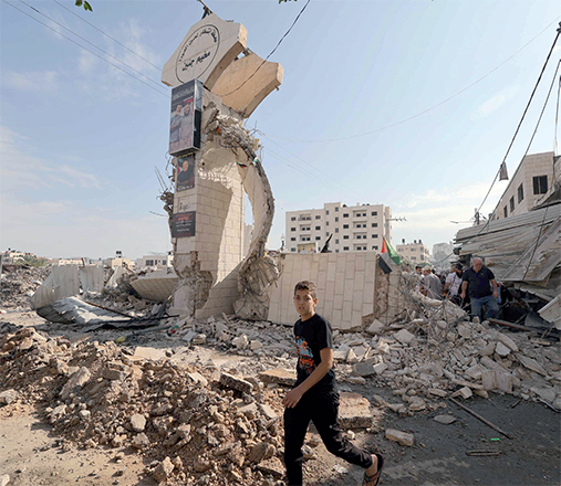 Palestinians survey the destruction following an Israeli military raid on the Jenin Palestinian refugee camp, in Jenin, in the Israeli occupied northern West Bank, on Monday (AFP photo)