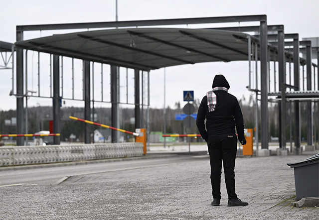 A man stands at the border between Russia and Finland at the Nuijamaa border check point in Lappeenranta, Finland on Wednesday (AFP photo)
