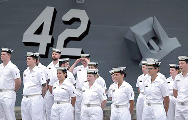 Sailors from the Royal Australian Navy stand in front of the Australian Navy destroyer HMAS Sydney, in Sydney, on Tuesday (AFP photo)