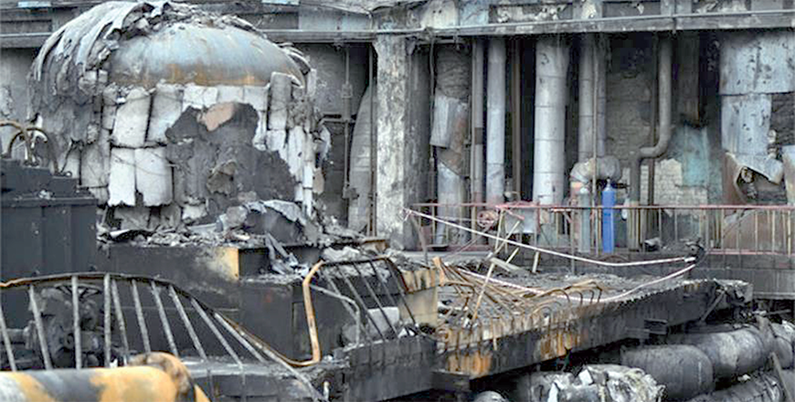 Workers clean debris in a turbine hall full of scorched equipment at a power plant of energy provider DTEK in an undisclosed location in Ukraine on April 19 (AFP photo)