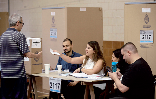 A man prepares to cast his vote at a polling station in Buenos Aires, during the presidential election runoff on Sunday (AFP photo)