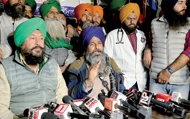 Swaran Singh Pandher (C seated), leader of a nationwide farmers’ association addresses a press conference amid a during a protest demanding minimum crop prices, near the Haryana-Punjab state border in Shambhu at Patiala district about 200 kilometres north of the capital on Wednesday (AFP photo)