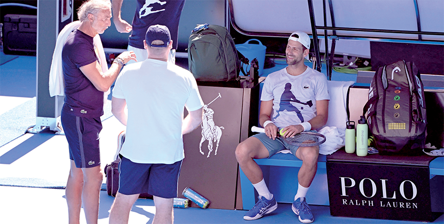 Serbia’s Novak Djokovic (right) chats to his team during a practice session ahead of the Australian Open tennis tournament in Melbourne on Tuesday (AFP photo)