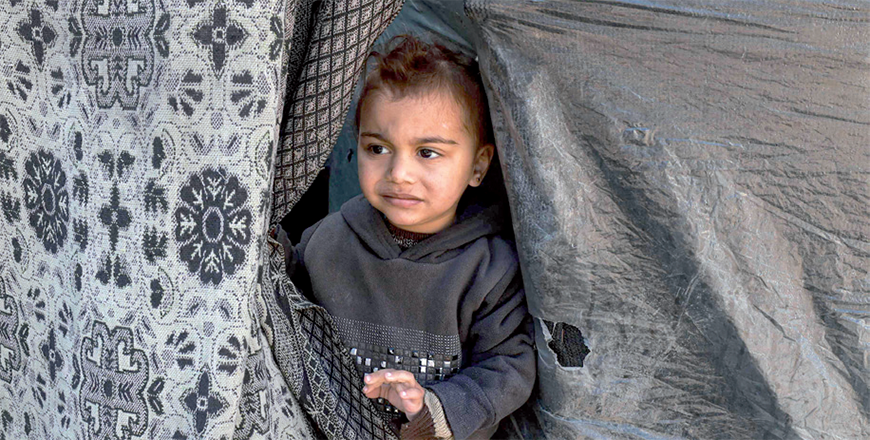 A child peeks out of a tent sheltering displaced Palestinians in Rafah in the southern Gaza Strip on Thursday, amid the ongoing Israeli offensive (AFP photo)