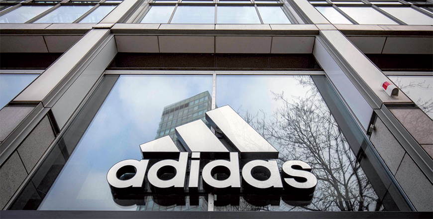 In this file photo taken on March 29, 2020, the logo of German sporting goods company Adidas is pictured at one of the company's outlets in Berlin, Germany (AFP file photo)