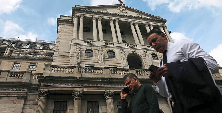 Pedestrians walk past the Bank of England building in London (AFP file photo)