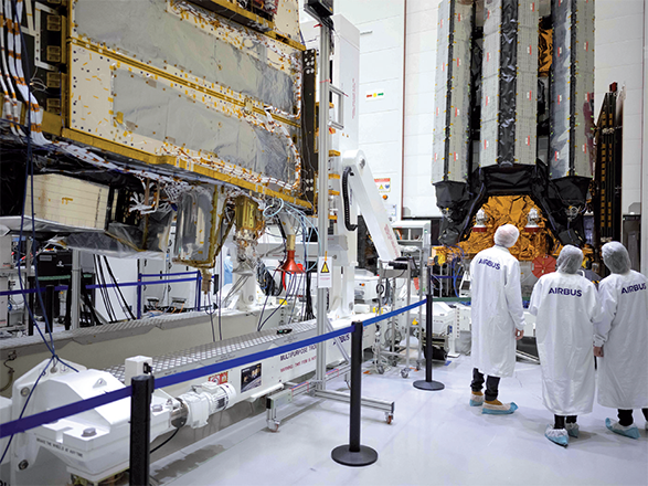 Airbus employees stand in front of the MetOp-SG A and MetOp-SG B MetOp-SG (Meteorological Operational Satellite - Second Generation) meteorological satellites in the clean room of the company's defense and space branch on Friday in Toulouse, south-western France (AFP photo)