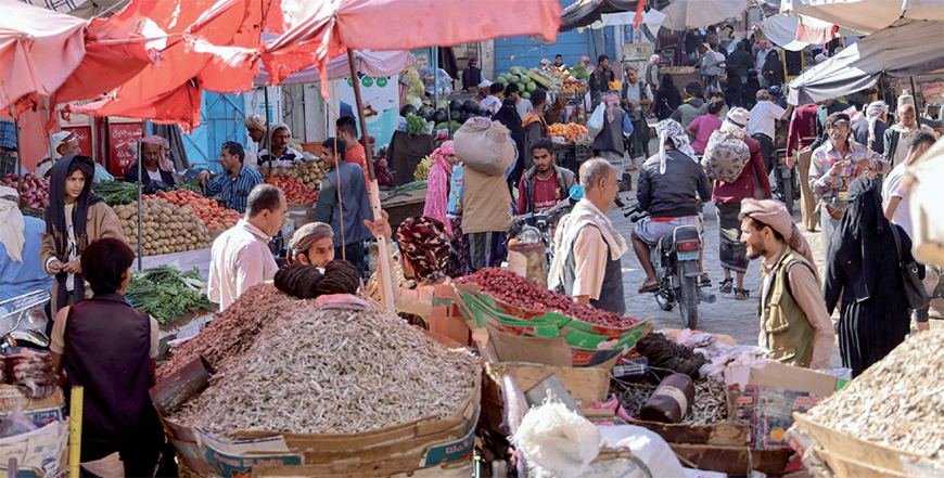 People shop at a street market in Yemen's third city of Taiz, on Wednesday (AFP photo)