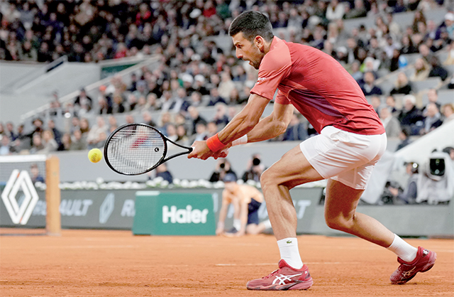 Serbia’s Novak Djokovic plays a backhand return to Spain’s Roberto Carballes Baena during their men’s singles match on Court Philippe-Chatrier on day five of the French Open tennis tournament at the Roland Garros Complex in Paris on Thursday (AFP photo)