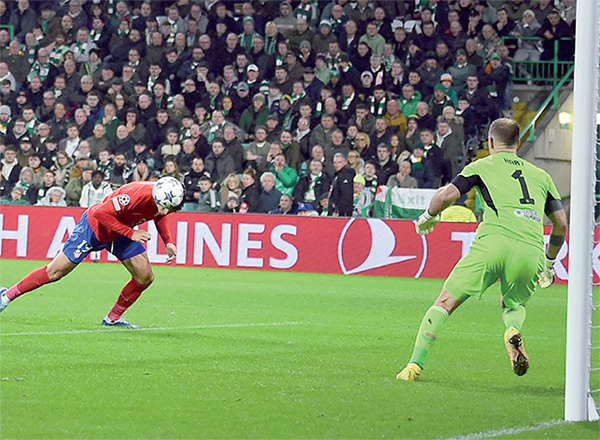Atletico Madrid’s Spanish striker #19 Alvaro Morata heads the ball and scores his team second goal during the UEFA Champions League group E football match between Celtic and Atletico Madrid at Celtic Park stadium in Glasgow, Scotland, on Wednesday (AFP photo)