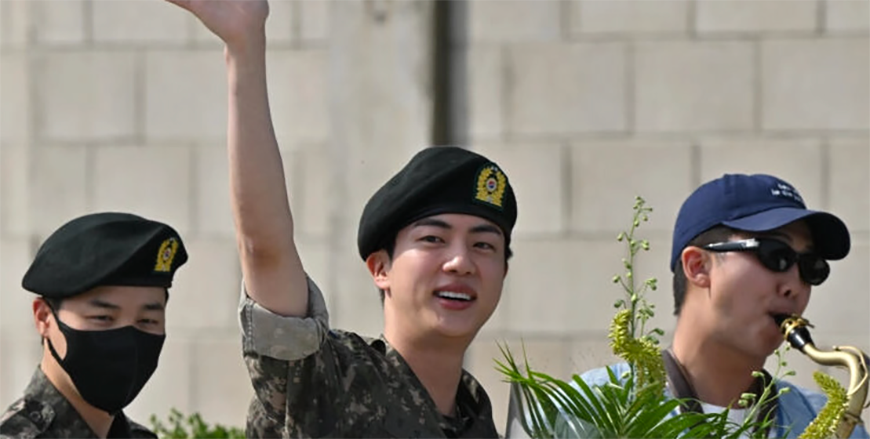 BTS superstar Jin (centre) is greeted by bandmates RM (right) and Jimin after being discharged from his mandatory military service (AFP photo)
