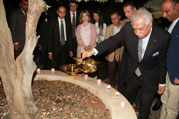 Amman Mayor Aqel Biltaji waters the 'Tree of Life' at the Martyrs' Park in Abdoun during a ceremony to mark the 11th anniversary of the hotel bombings in the capital on Wednesday (Photo by Osama Aqarbeh)