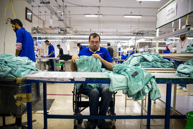 Sufian Malalha, a person with a physical disability, works at a garment factory in Sahab, where 50 of the 2,800 employees are people with disabilities (JT photo)