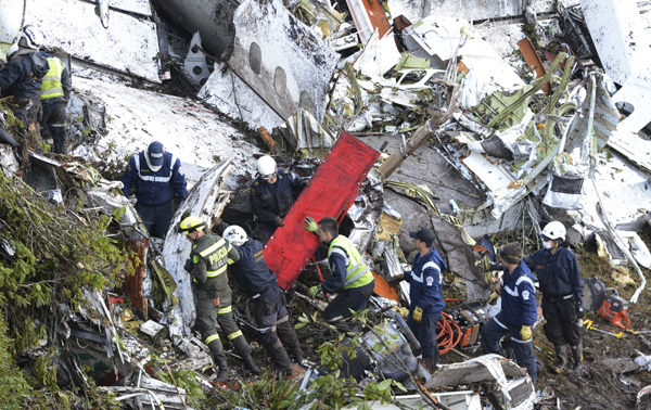 Rescue workers comb through the wreckage site of an airplane crash in La Union, a mountainous area near Medellin, Colombia, on Tuesday (AP photo)