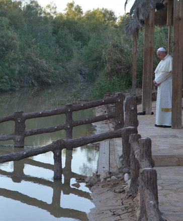 Pope Francis prays at the Baptism Site during a visit to Jordan in May 2014 (Photo by Muath Freij)