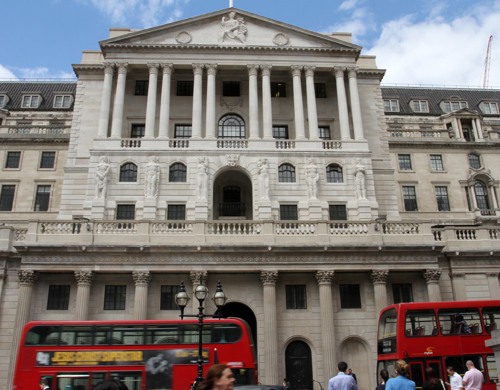 Buses and pedestrians pass the Bank of England in London on Thursday (AP photo)