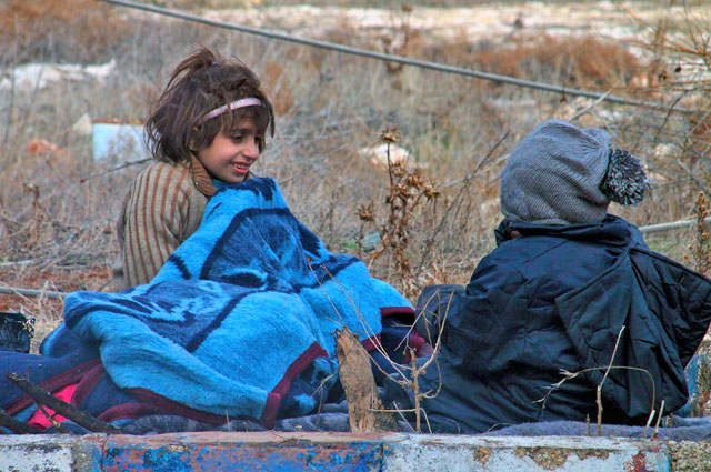 This photo released on Friday by Aleppo 24 shows children of eastern Aleppo sitting on the ground in western rural Aleppo, Syria (AP photo)