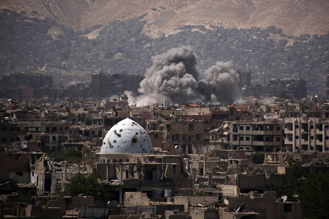 A general view shows moke rising from buildings following an air strike on Jobar, a rebel-held district on the eastern outskirts of the Syrian capital Damascus on Saturday (AFP photo)