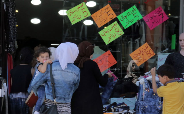 Customers check out offers at a clothing store in downtown Amman earlier this week (Photo by Osama Aqarbeh)