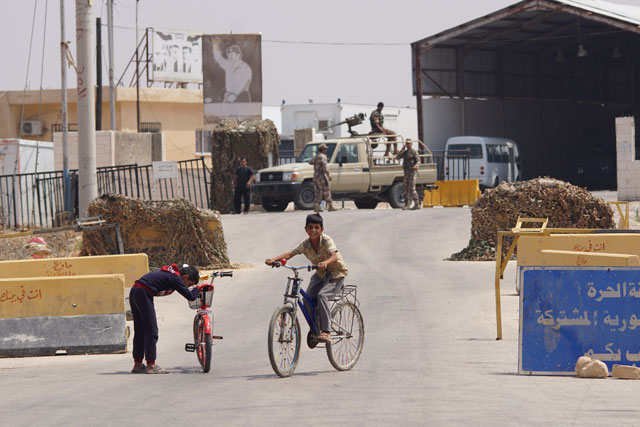 In this recent photo, children play at the Jaber/Nasib border crossing with Syria after Syrian government forces restored the facility from rebels last month (Photo by Amjad Ghsoun)