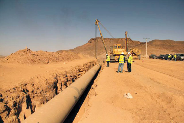 In this undated file photo, workers install pipes as part of the Disi Water Conveyance Project, which was concluded in 2014 (File photo)