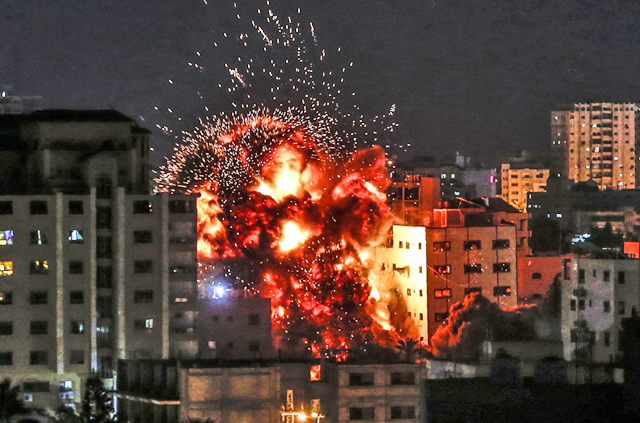   An explosion is pictured among buildings during an Israeli air strike on Gaza City on Saturday (AFP photo)