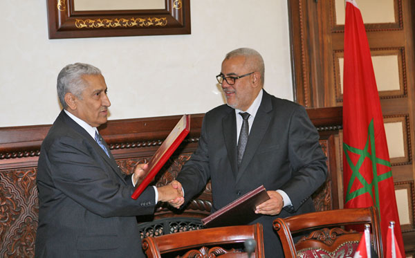 Prime Minister Abdullah Ensour exchanges signed agreements with his Moroccan counterpart Abdelilah Benkirane in Rabat on Friday (Petra photo)
