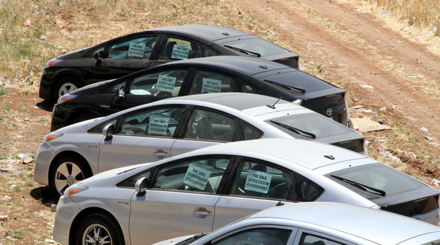 Hybrid cars for sale are seen on the side of a street in Amman recently (File photo)