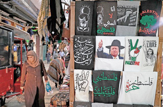 A T-shirt bearing an image of US President Donald Trump dressed as a Hasidic Jew is displayed in a souvenir shop in Jerusalem’s Old City on Monday (AFP photo)