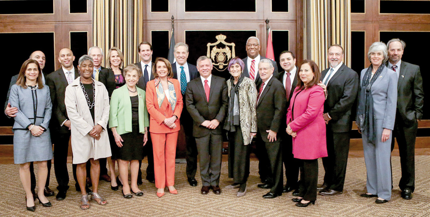His Majesty King Abdullah poses for a group photo with a US congressional delegation in Amman on Sunday (Photo courtesy of Royal Court)