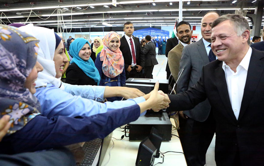 His Majesty King Abdullah is greeted by workers in a garment factory in Madaba on Monday (Photo courtesy of Royal Court)
