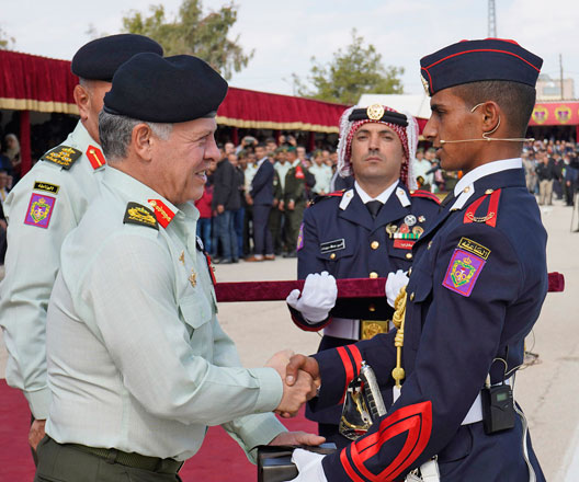 His Majesty King Abdullah awards top graduates of the second batch of 'Knights of the Future' officers during a graduation ceremony at the Royal Military College on Monday (Photo courtesy of Royal Court)