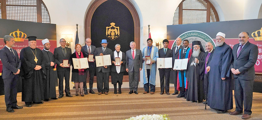 His Majesty King Abdullah is photographed with winners of the 2019 King Abdullah II World Interfaith Harmony Week Prize and a number of Muslim and Christian religious leaders following the prize ceremony (Photo courtesy of Royal Court)