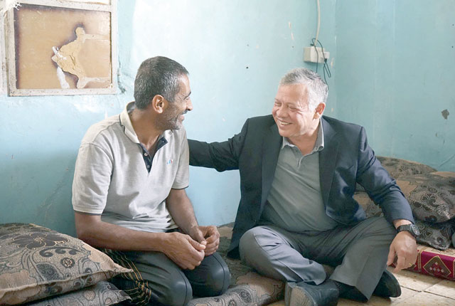 His Majesty King Abdullah visits an underprivileged family in Al Mukheiba town in Irbid Governorate on Friday (Photo courtesy of Royal Court)