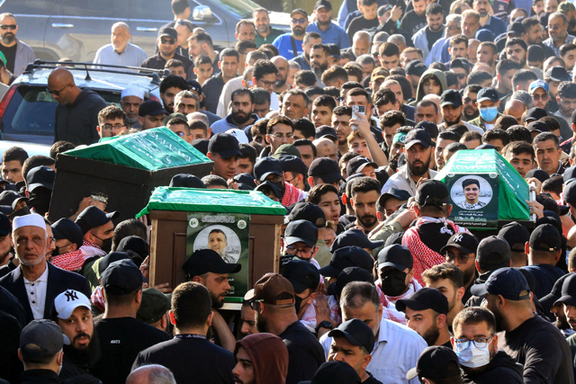 Mourners carry the caskets of slain Palestinian militant group Hamas commander Hassan Farhat (C), his son Hamza (R) and daughter Jenan (L), who were killed in an Israeli drone strike that targeted their apartment in the southern Lebanese city of Sidon, during their funeral procession on April 4, 2025 (AFP photo)